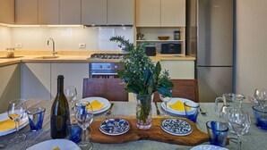A modern kitchen with a dining area set for a meal.
