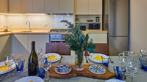 A modern kitchen with a dining area set for a meal.