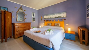 A bedroom with a bed, dresser, nightstand, and wall art. - Rebecca's House among the greenery, Bardonecchia, Italy (Bardonecchia)
