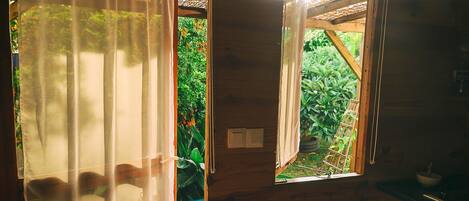 A wooden cabin with a window and a door.