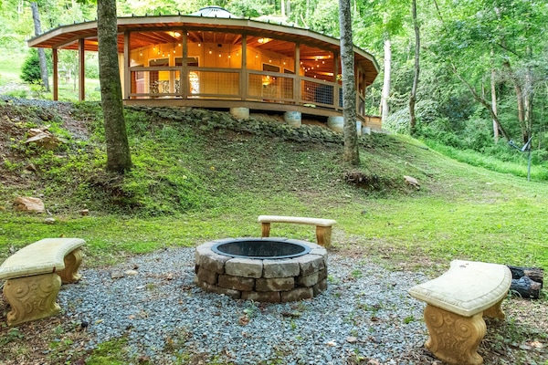 Gather around the stone fire pit as the yurt glows warmly above you, string lights twinkling on the deck and nothing but forest and fireflies all around.