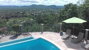 A pool area with a view of a mountainous landscape.