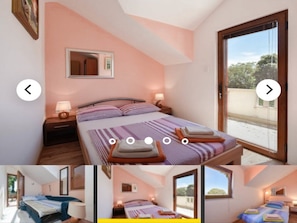 Ein Schlafzimmer mit Bett, Nachttischen, einem Spiegel und einem Fenster.