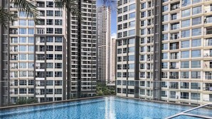 A modern high-rise building with a swimming pool in the foreground. - Landmark 81 Serviced Residences (Ho Chi Minh City)