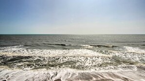 A beach with waves and a clear sky. - Kure Beach Condo w/ Panoramic Ocean Views! (Kure Beach)