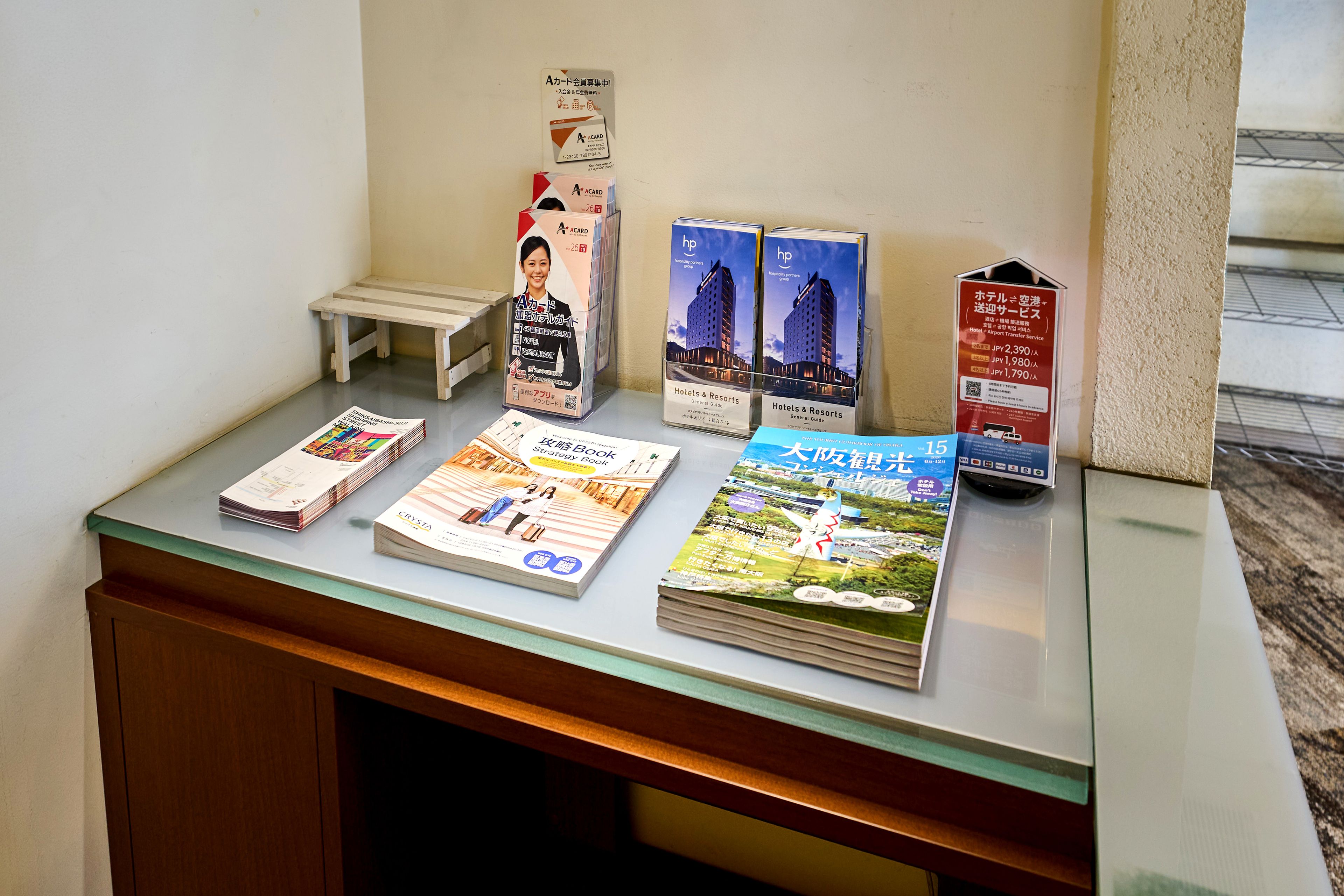 A display of travel brochures and informational pamphlets on a counter.