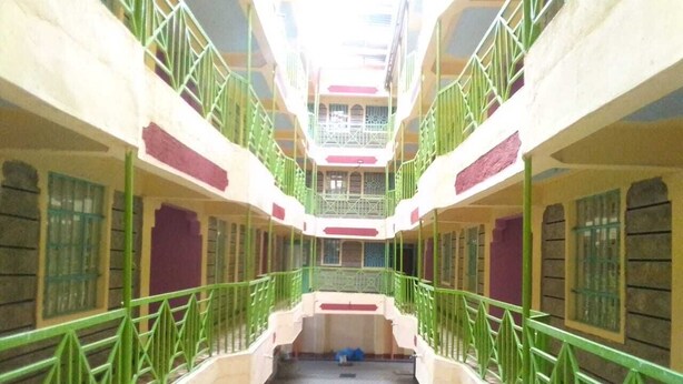 A multi-level atrium with green railings and a central staircase. - Mongare Lodge and restaurant (Narok)