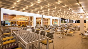 A spacious indoor dining area with multiple tables and chairs, large windows, and a modern ceiling design. - HOTEL NAIS (Vrtiste)