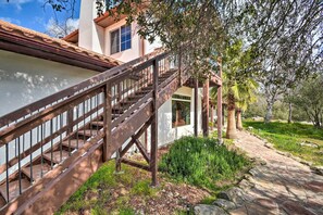 Stunning Mediterranean-style home with a beautiful balcony and lush garden.