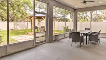 Enjoy dining or socializing in this outdoor space with a view of the backyard.