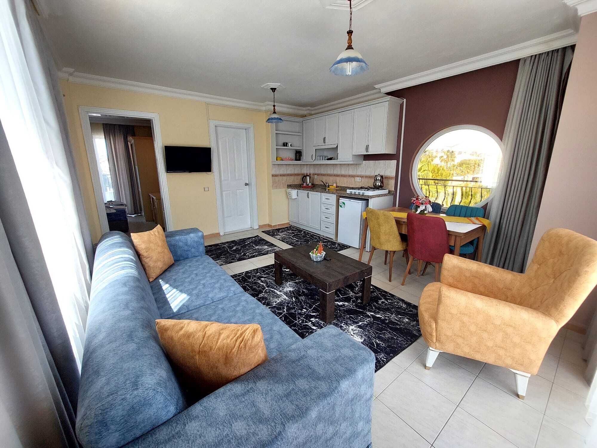 family quadruple room, non smoking, pool view | living area | tv