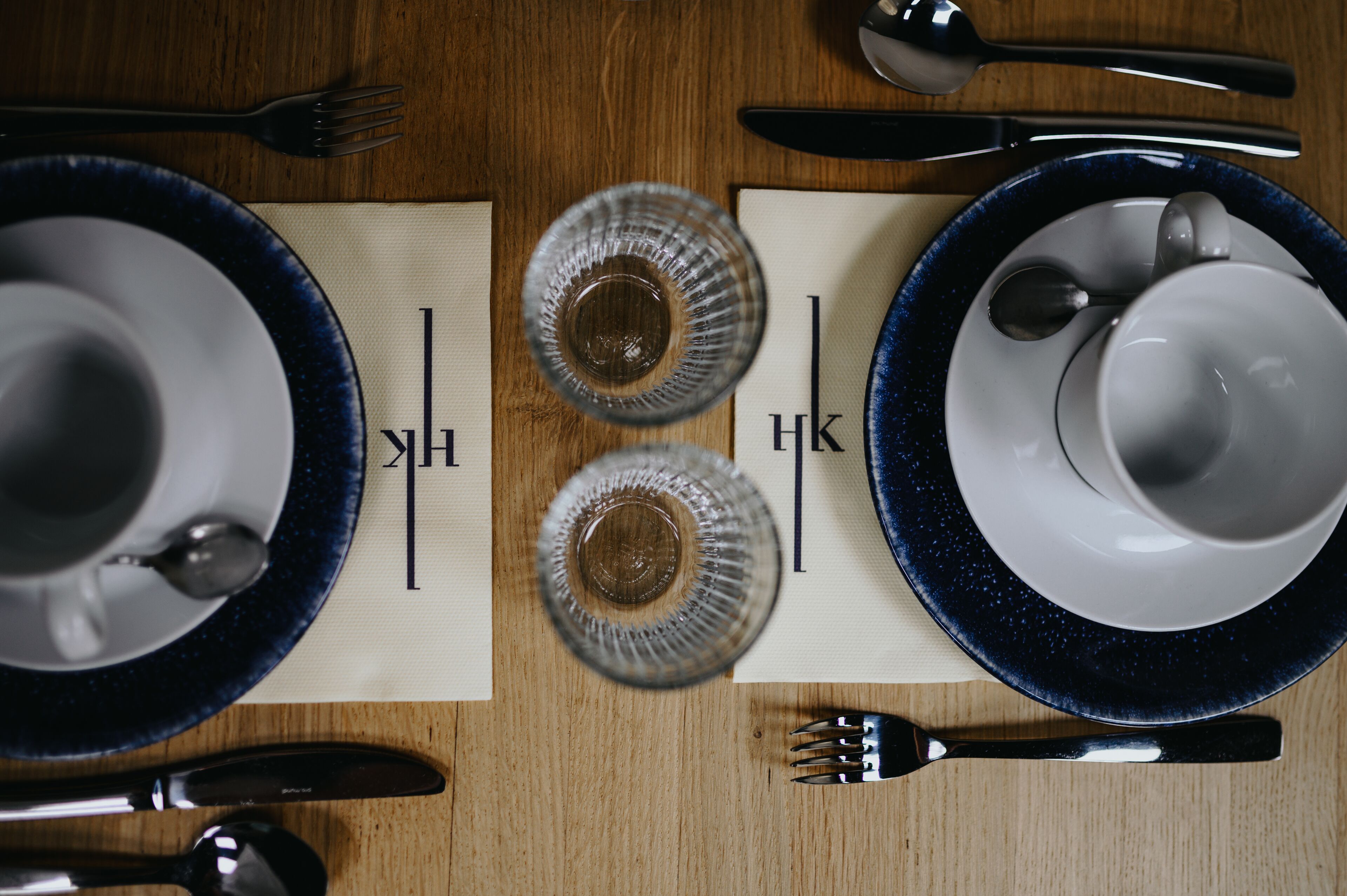 A table set with plates, glasses, and cutlery.