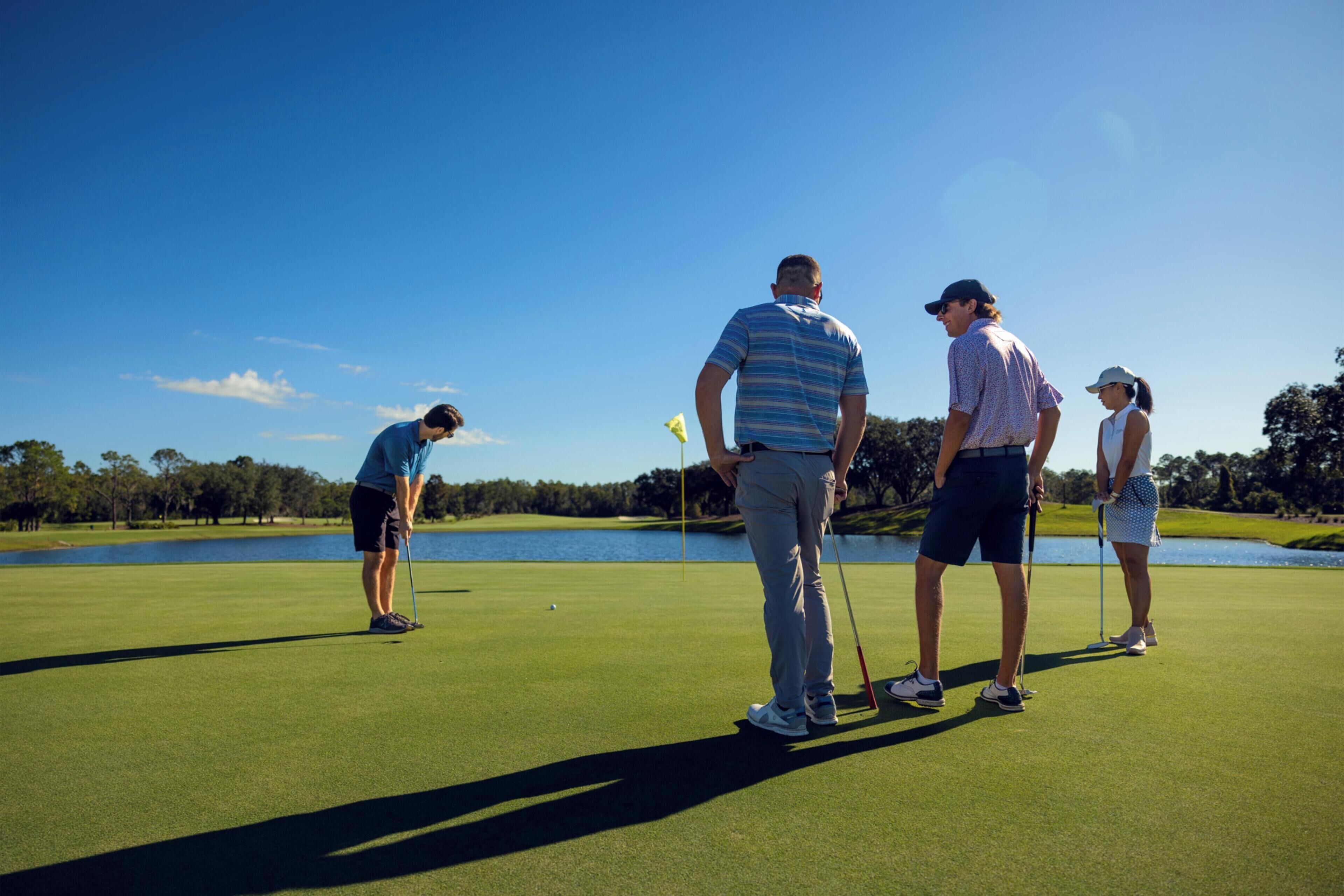 A golf course with a lake in the background.