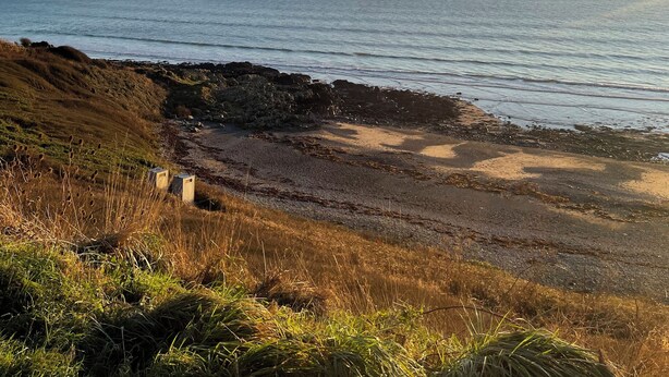 A coastal landscape with a clear sky, rocky shoreline, and grassy terrain. - Beautiful 2-bed Static Caravan (Newton Stewart)