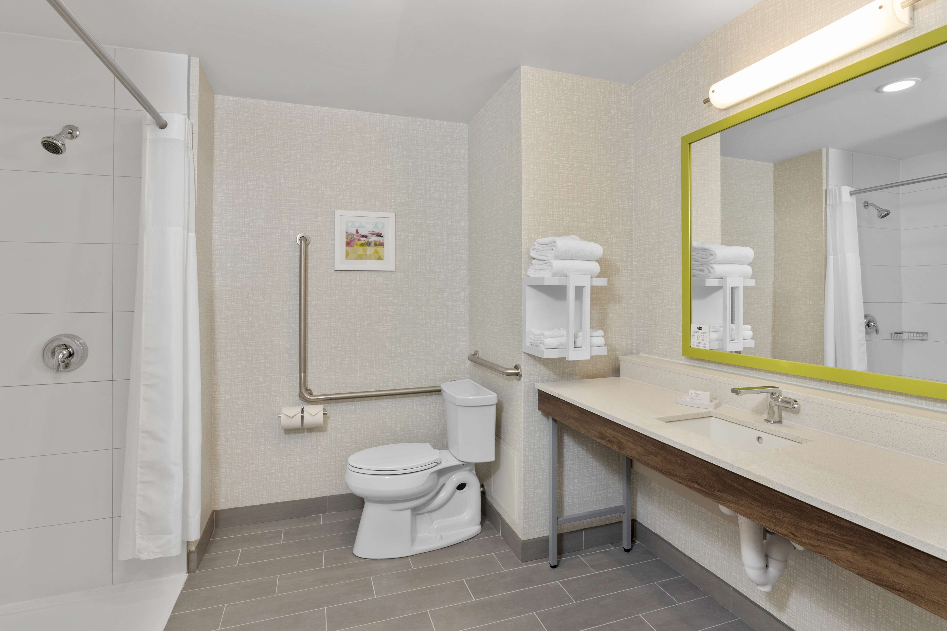 A modern bathroom with a shower, toilet, and sink.