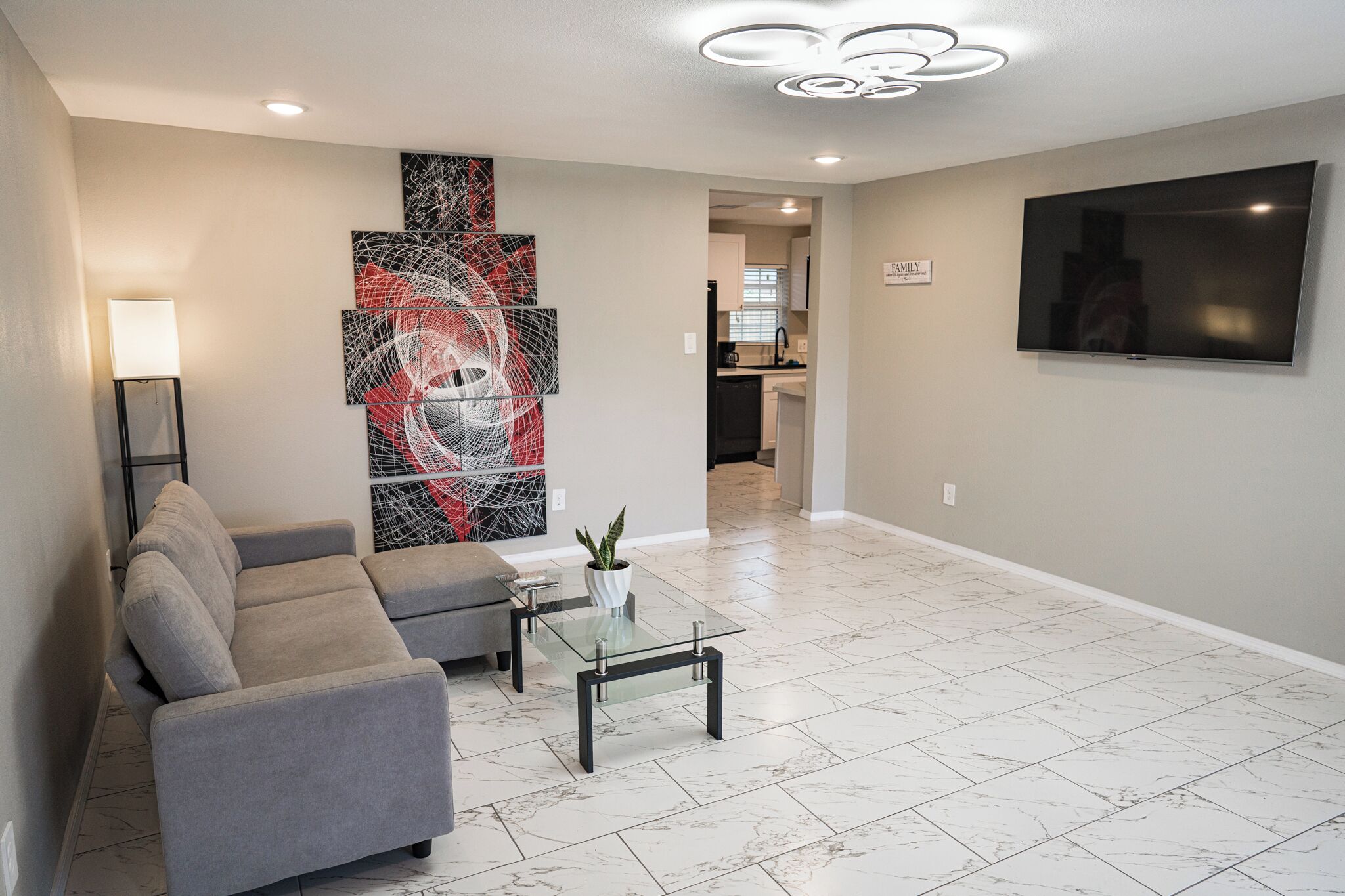 Huge Living Area with 65 inch Smart TV, Couch, Coffee Table. 