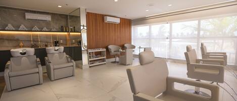 A modern waiting area with multiple seating options, a reception desk, and a large window providing natural light.