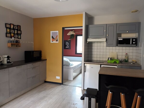 A compact kitchen with grey cabinets, a microwave, and a small sink. - HOLIDAY HOME CLOSE TO BEACH AND POOL (Moliets-et-Maa)