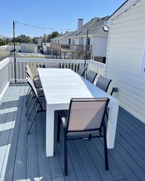 Enjoy outdoor dining on the deck with a long table and six chairs.