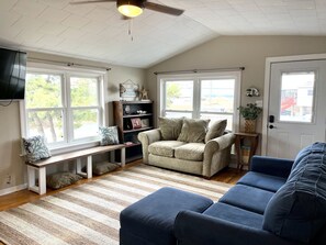 Relax in this inviting living room with a bench, sofa, and sectional sofa, perfect for unwinding.