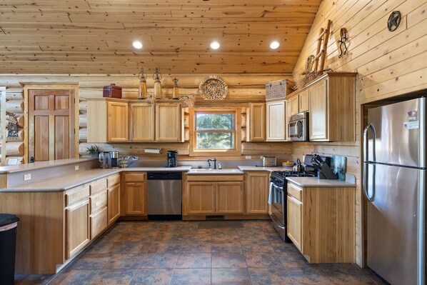 Enjoy cooking in this well-equipped kitchen with a central island and stainless steel appliances.