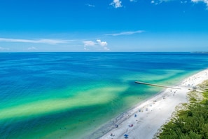 A beach with clear turquoise waters and a sandy shore. - AMI Lighthouse Cottage-one Minute Walk To The Beach-keyless Locks (Bradenton Beach)