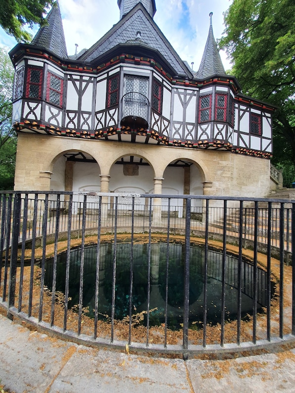 A historic building with a central courtyard and a reflective water feature.