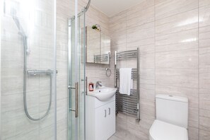 Departamento Confort, baño en la habitación, vista al jardín | Baño