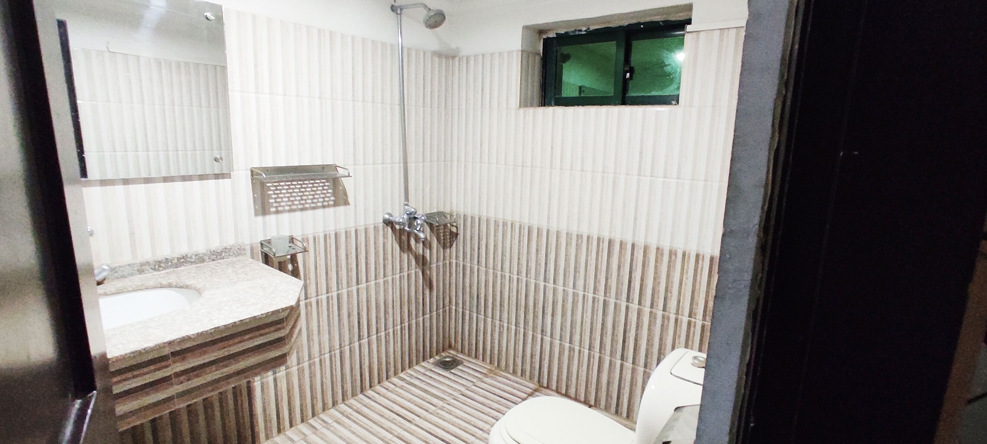 Un baño con ducha, inodoro y lavamanos.