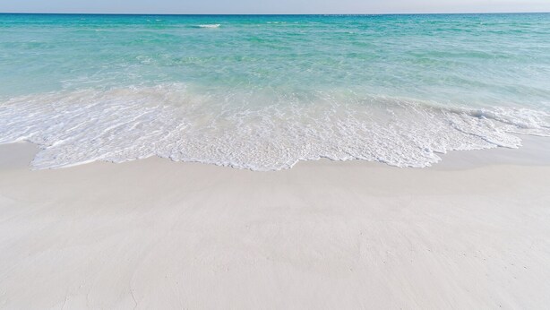 A beach with clear turquoise water and white sand. - 5mins Steps to Beach | Fenced Heated Pool w/ Grill (Miramar Beach)