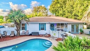 A house with a swimming pool, a patio with chairs, and a small deck. - 5mins Steps to Beach | Fenced Heated Pool w/ Grill (Miramar Beach)
