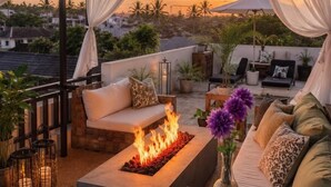 A rooftop terrace with a fire feature, outdoor seating, and a view of the cityscape. - 30% off! 8-3BR En Suites,Ultra Modern Best Of The Best In SeminyaksBest Location (Seminyak)