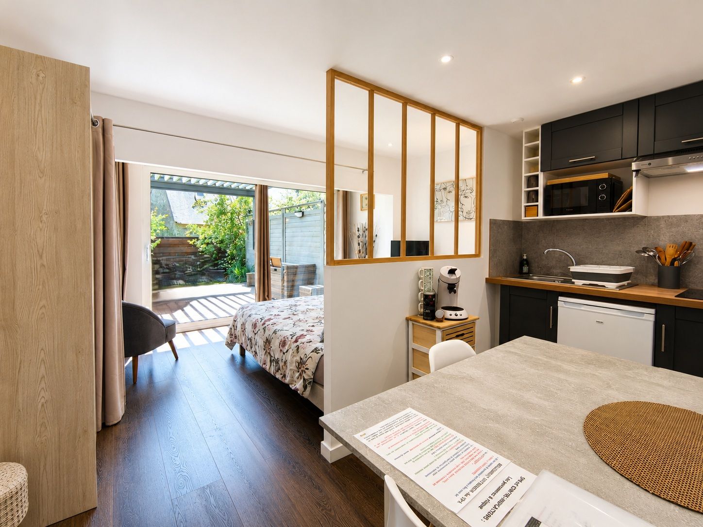 A modern kitchen with a built-in microwave, a sink, and a coffee machine.
