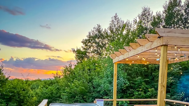 A wooden deck with a hot tub, a fire pit, and outdoor seating. - Private Romantic Luxury Yurt- Sunset deck with Mt Views-Hot Tub-AC-WiFi-Fire Pit (Woodstock)
