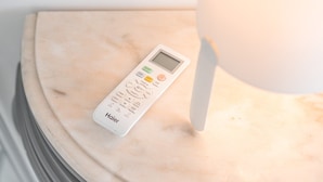 A white Haier thermostat on a marble surface. - GuestReady  Economy - Gold Leaf 2B (Porto)