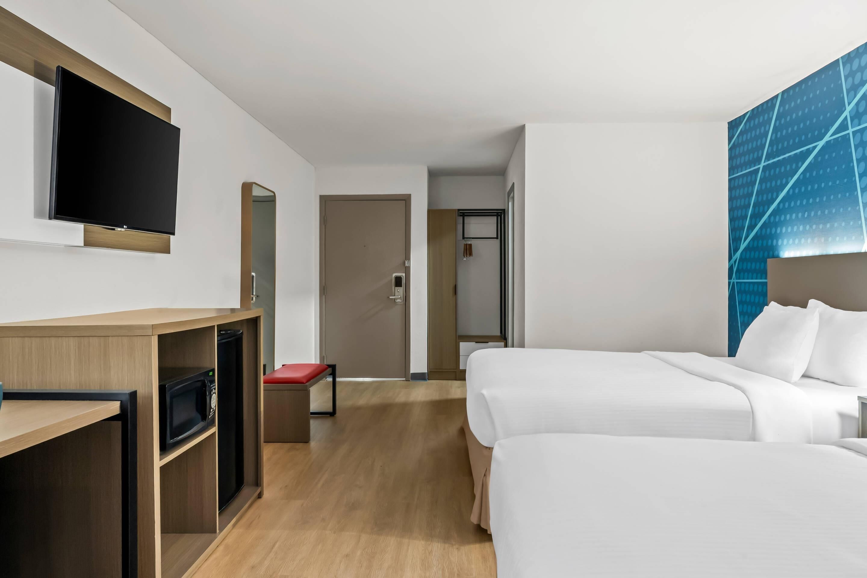 Premium bedding, memory-foam beds, laptop workspace, blackout curtains