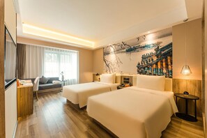 A hotel room with two beds, a sofa, a desk, a lamp, and a large wall mural. - Yaduo Hotel Beijing Zhongguancun Life Science Park (Beijing)