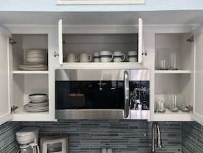 Microwave, dishwasher, coffee/tea maker, cookware/dishes/utensils
