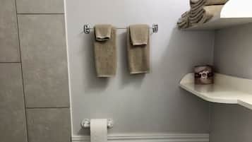 Habitación individual Confort | Baño | Tina con regadera, toallas, jabón, shampoo