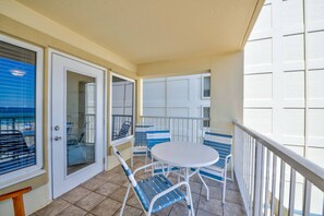Enjoy a quiet moment on the balcony with a small table and four chairs.