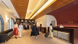 A hotel reception area with a modern design, including a reception desk, seating area, and a check-in counter.
