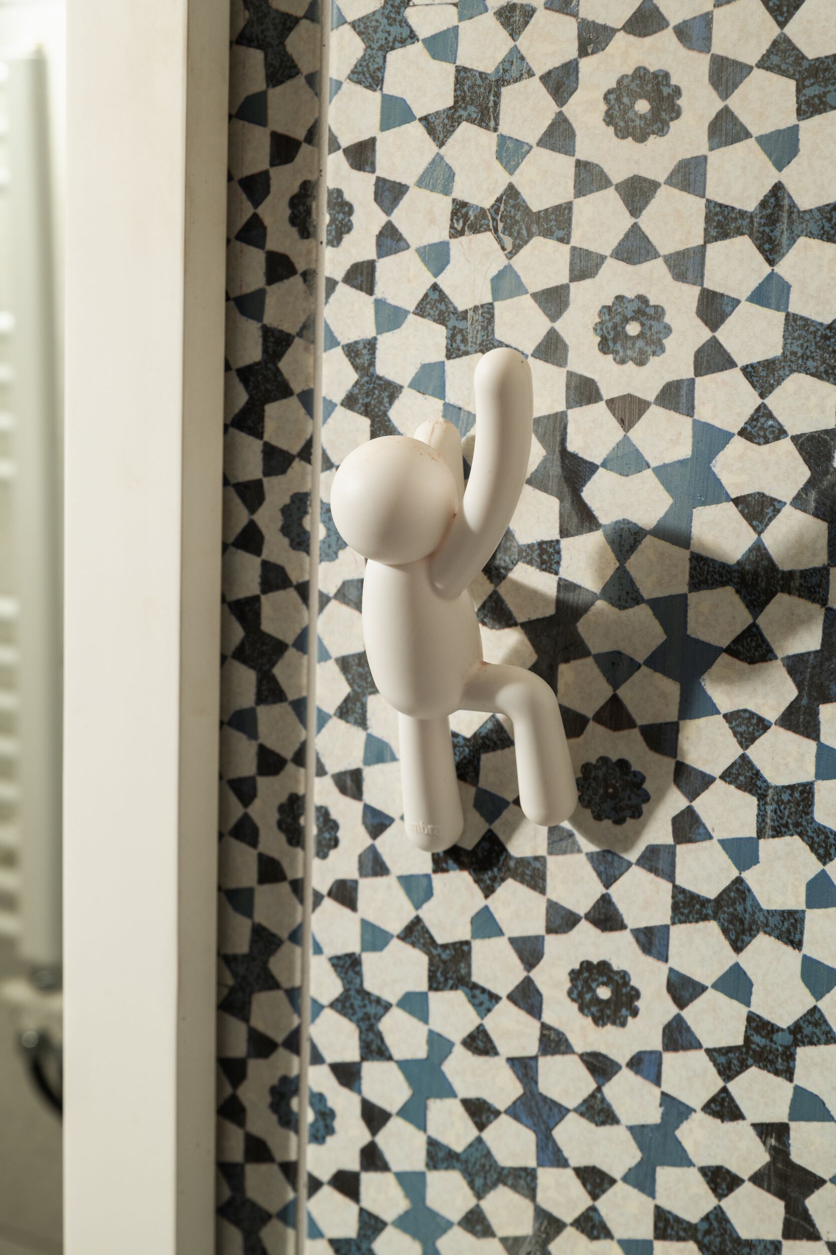 A room with a patterned wall and a white door.