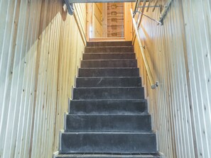 A staircase leading to a wooden door with a window. - Old logger´s house by Interhome (Salla)