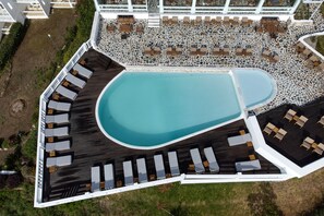 An aerial view of a poolside area with sun loungers and a swimming pool. - Oniro Skiathos (Skiathos)