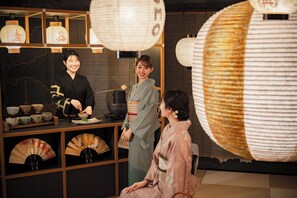 A traditional Japanese tea ceremony setting with a tea house, utensils, and fans. - OMO5 Kyoto Gion by Hoshino Resorts (Kyoto)