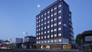 A modern hotel with multiple floors, large windows, and a visible sign indicating it is an ONA hotel. - OMO3 Kyoto Toji by Hoshino Resorts (Kyoto)