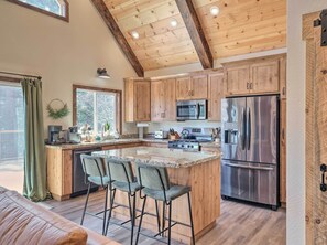 Enjoy casual dining and ample workspace in this kitchen with a central island and bar stools.