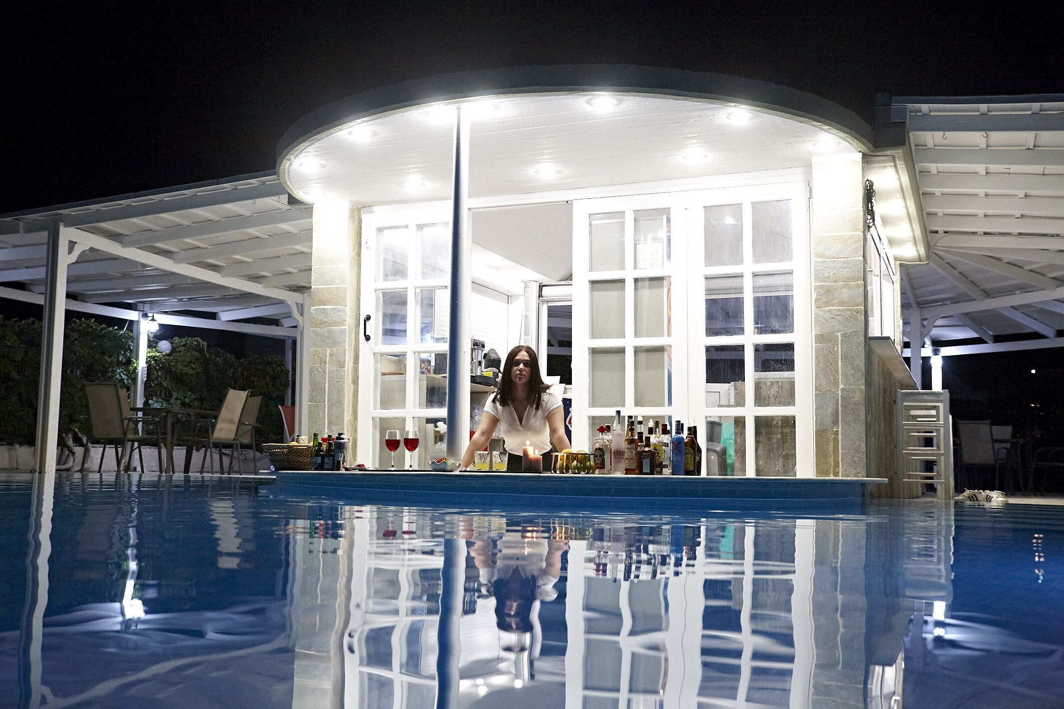 A pool area with a bar and seating.