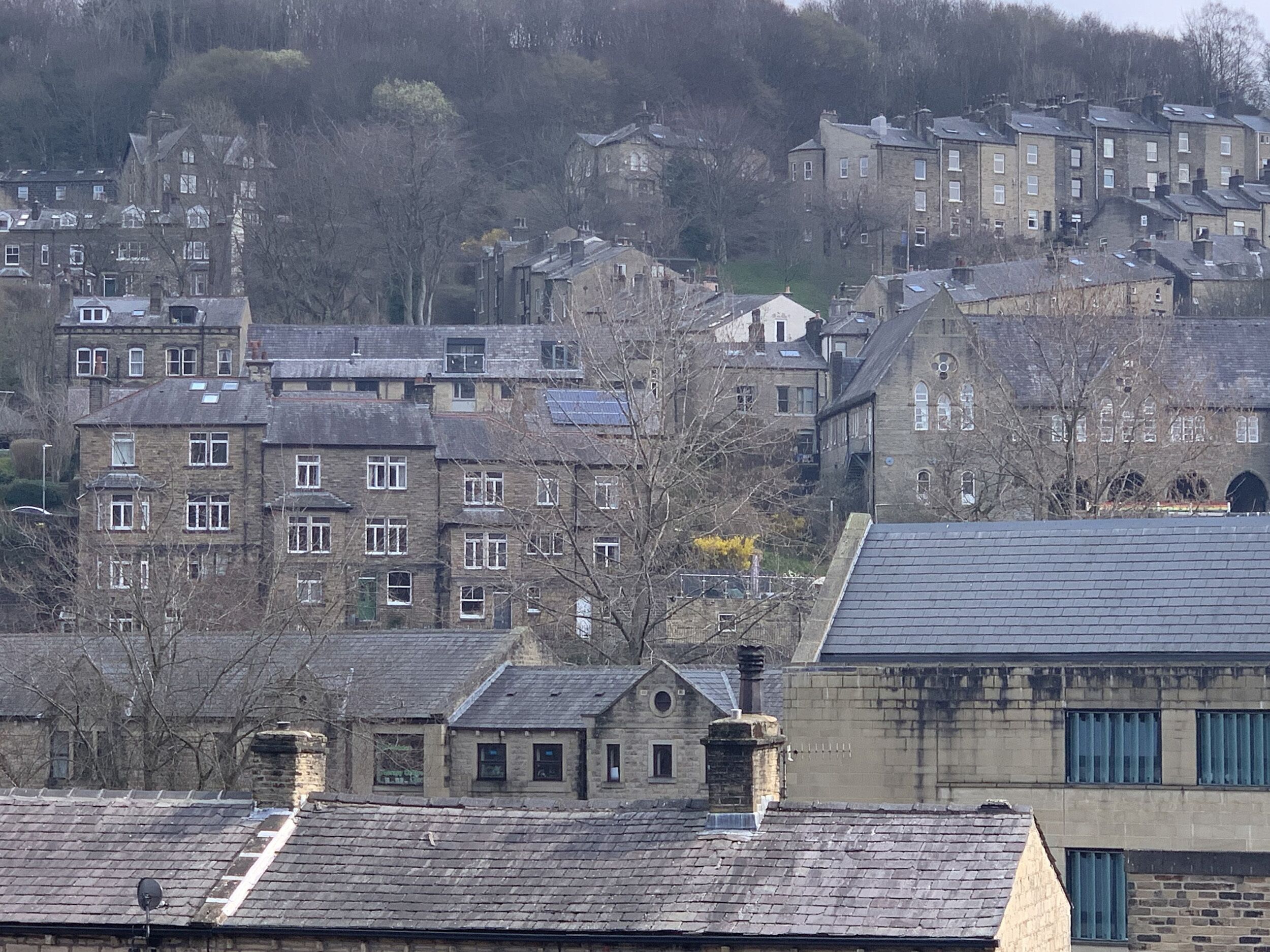 A residential area with multiple two-story houses, some with visible chimneys and satellite dishes.