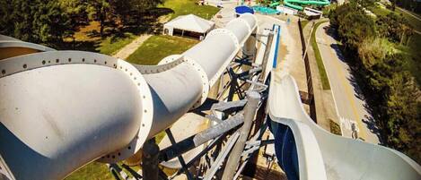 A water park with a large water slide and a view of the surrounding area.